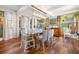 Bright dining room features a glass table, unique artwork, hardwood floors, and stylish seating at 356 22Nd Ne Ave, St Petersburg, FL 33704