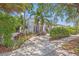 Charming home with lush landscaping, mature trees, and a patterned driveway at 356 22Nd Ne Ave, St Petersburg, FL 33704