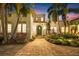 Enchanting twilight view of home with inviting paver driveway and professionally landscaped yard at 356 22Nd Ne Ave, St Petersburg, FL 33704