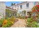Exterior view features a beautiful garden, fountain, and a charming turquoise door, enhancing its curb appeal and inviting atmosphere at 356 22Nd Ne Ave, St Petersburg, FL 33704