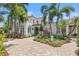 Stunning home with landscaped front yard, mature palms, and an inviting paver driveway at 356 22Nd Ne Ave, St Petersburg, FL 33704