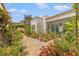 Exterior view of home, showcasing a beautiful garden, water feature, and charming turquoise door, enhancing its curb appeal at 356 22Nd Ne Ave, St Petersburg, FL 33704
