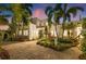 Elegant two-story home featuring lush landscaping, a cobblestone driveway, and a stucco facade at 356 22Nd Ne Ave, St Petersburg, FL 33704