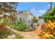 Charming exterior with stucco walls, red tile roof, lush landscaping and brick-paved walkway at 356 22Nd Ne Ave, St Petersburg, FL 33704