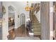 Grand foyer with hardwood floors, a curved staircase, and elegant light fixture at 356 22Nd Ne Ave, St Petersburg, FL 33704