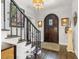 Bright foyer featuring hardwood floors, a staircase, and a wooden front door at 356 22Nd Ne Ave, St Petersburg, FL 33704