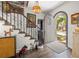 Open foyer with hardwood floors, a wooden door, and a staircase with iron railing at 356 22Nd Ne Ave, St Petersburg, FL 33704