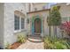 Charming front entrance with arched doorway, decorative stonework, and lush landscaping at 356 22Nd Ne Ave, St Petersburg, FL 33704