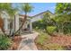 Inviting front porch with a stone walkway, mature landscaping, and stucco columns at 356 22Nd Ne Ave, St Petersburg, FL 33704