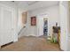 Hallway with light walls and art on display leading to a peek of another room at 356 22Nd Ne Ave, St Petersburg, FL 33704