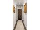 Hallway with archway, unique wooden double doors, art, and hardwood flooring at 356 22Nd Ne Ave, St Petersburg, FL 33704