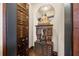 Unique hallway featuring a decorative cabinet with statues and a mirror, adding character and charm to the home's interior at 356 22Nd Ne Ave, St Petersburg, FL 33704