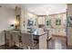 Bright kitchen showcases an island with seating, white cabinetry, stainless appliances, and hardwood flooring at 356 22Nd Ne Ave, St Petersburg, FL 33704
