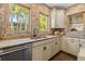 Bright kitchen showcases stainless steel appliances, a double sink, large windows and custom tile backsplash at 356 22Nd Ne Ave, St Petersburg, FL 33704