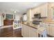 An eat-in kitchen includes an island, stainless appliances, custom cabinets and hardwood floors at 356 22Nd Ne Ave, St Petersburg, FL 33704