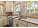 Bright kitchen features stainless steel appliances, a double sink, and large windows offering an outdoor view at 356 22Nd Ne Ave, St Petersburg, FL 33704
