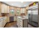 Light-filled kitchen features an island, stainless steel appliances, custom cabinets and unique backsplash at 356 22Nd Ne Ave, St Petersburg, FL 33704