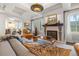 A bright living room highlighting a fireplace, large windows, and comfortable seating at 356 22Nd Ne Ave, St Petersburg, FL 33704