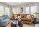 Bright living room featuring an ornate sofa, white curtains, and a decorative wall hanging at 356 22Nd Ne Ave, St Petersburg, FL 33704