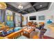 Open living room with coffered ceiling, large TV, hardwood floors, and stylish furnishings at 356 22Nd Ne Ave, St Petersburg, FL 33704