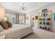 Bright main bedroom with French doors, decorative gold shelving, and neutral decor at 356 22Nd Ne Ave, St Petersburg, FL 33704