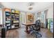 An office with hardwood floors, large desk, two bookshelves, and lots of art at 356 22Nd Ne Ave, St Petersburg, FL 33704
