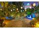 Inviting patio area with stylish outdoor seating, lush tropical plants, and ambient lighting at 356 22Nd Ne Ave, St Petersburg, FL 33704
