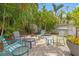 Cozy brick patio with colorful patio furniture and lush landscaping, creating a welcoming outdoor space at 356 22Nd Ne Ave, St Petersburg, FL 33704