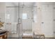 A spacious, glass-enclosed shower featuring multiple shower heads, neutral tiling, and a built-in bench at 356 22Nd Ne Ave, St Petersburg, FL 33704