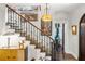 Detailed staircase with decorative iron railing and artwork adorning the walls at 356 22Nd Ne Ave, St Petersburg, FL 33704