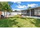 Well-maintained backyard featuring a built-in bench, green lawn, and tropical landscaping at 3709 W Santiago St, Tampa, FL 33629