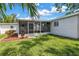 Spacious backyard featuring a screened patio and lush green grass at 3709 W Santiago St, Tampa, FL 33629