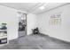 Unfinished basement with white walls, concrete floor, and an open doorway to a storage room at 3709 W Santiago St, Tampa, FL 33629