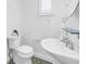 Charming bathroom with pedestal sink, patterned floors, and a window shutter at 3709 W Santiago St, Tampa, FL 33629