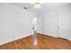 Bright bedroom with hardwood floors, neutral walls, and a ceiling fan at 3709 W Santiago St, Tampa, FL 33629