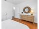 Bedroom with a wood floor and a dresser with a round mirror at 3709 W Santiago St, Tampa, FL 33629