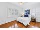 Bright bedroom with two windows, wood floors, and neutral decor at 3709 W Santiago St, Tampa, FL 33629