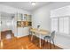 Cozy dining area featuring built-in cabinets, a window with shutters, and hardwood flooring at 3709 W Santiago St, Tampa, FL 33629
