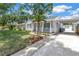 Charming home with a well-maintained front lawn, a small porch, and an adjacent carport at 3709 W Santiago St, Tampa, FL 33629