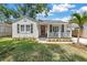 Charming single-story home featuring a red front door, white picket fence, and a well-manicured lawn at 3709 W Santiago St, Tampa, FL 33629