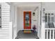 Charming front entrance with a vibrant orange door, decorative plants, and a welcoming 'welcome' mat at 3709 W Santiago St, Tampa, FL 33629