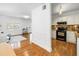 Open concept living room with hardwood floors seamlessly flowing into an updated kitchen with modern appliances at 3709 W Santiago St, Tampa, FL 33629