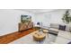 Cozy living room with modern furnishings, wood floors, and shuttered windows at 3709 W Santiago St, Tampa, FL 33629