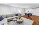 Comfortable living room featuring a sectional sofa, wood floors, and stylish decor at 3709 W Santiago St, Tampa, FL 33629