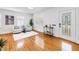 Well-lit living room featuring hardwood floors, neutral decor, plantation shutters, and a decorative wine cart at 3709 W Santiago St, Tampa, FL 33629