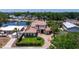 An aerial view of a luxury Mediterranean home with a tile roof, lush landscaping, and a circular driveway at 3931 Pompano Se Dr, St Petersburg, FL 33705