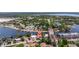 An aerial view of a waterfront property in a community with lush trees, and a view of the bay at 3931 Pompano Se Dr, St Petersburg, FL 33705