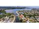 An aerial view of a waterfront community with homes along the canal and downtown in the background at 3931 Pompano Se Dr, St Petersburg, FL 33705