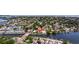 An aerial view of a waterfront community with homes along the canal and mature trees at 3931 Pompano Se Dr, St Petersburg, FL 33705