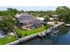 An aerial view of a backyard with a screened-in pool, a covered patio, and a boat dock at 3931 Pompano Se Dr, St Petersburg, FL 33705